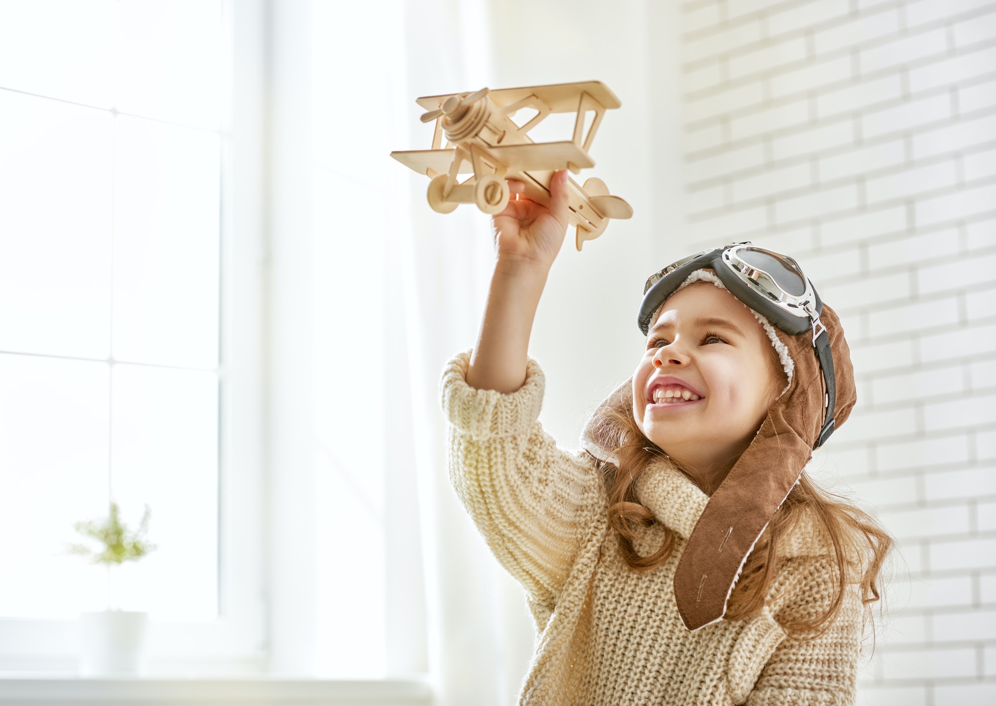 girl-playing-with-toy-airplane